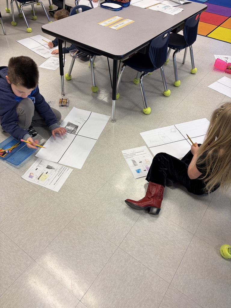 Kindergarten kid working a project at their desk