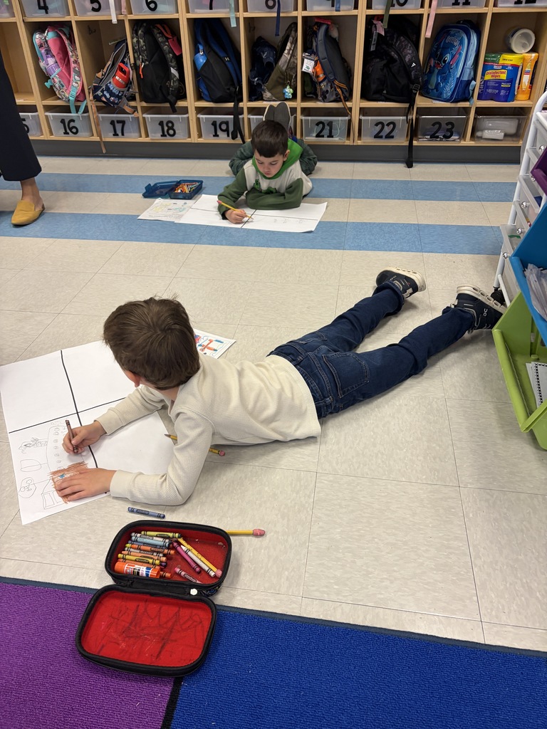 Kindergarten kid working a project at their desk