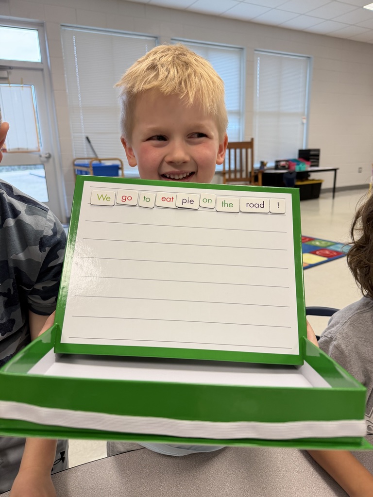 1st grader holding up a sentence they made