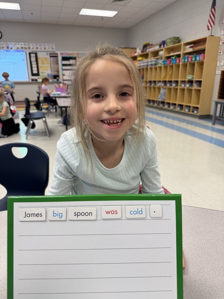 1st grader holding up a sentence they made