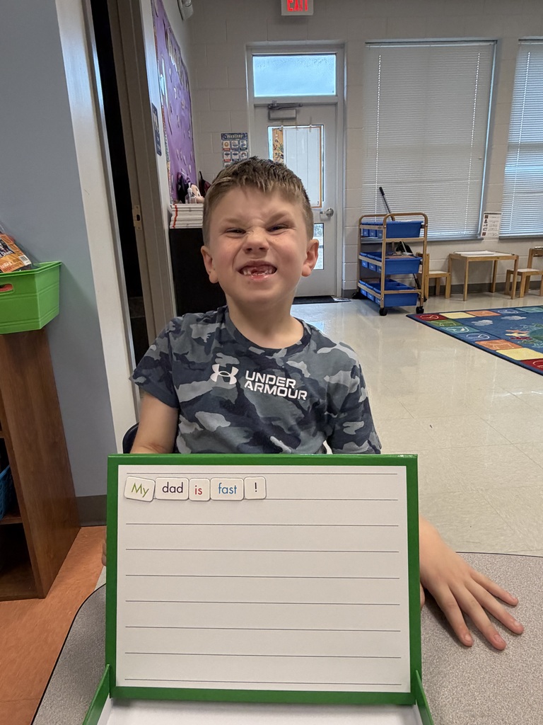 1st grader holding up a sentence they made