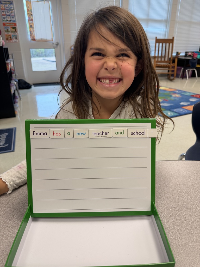 1st grader holding up a sentence they made