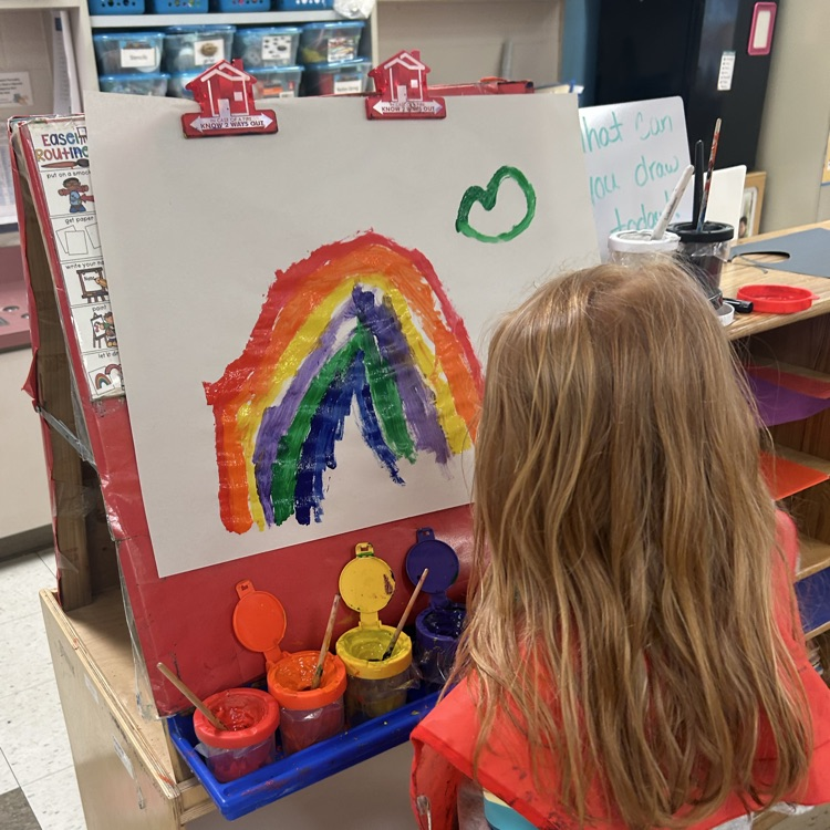 child panting a rainbow