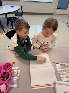 first graders working in pairs during a math game