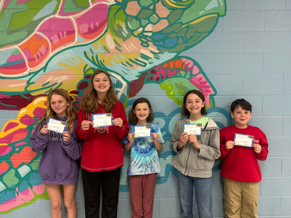 students holding up certificates 