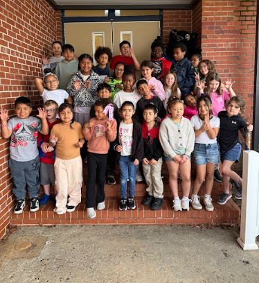 students of the week standing on school steps with the mascot