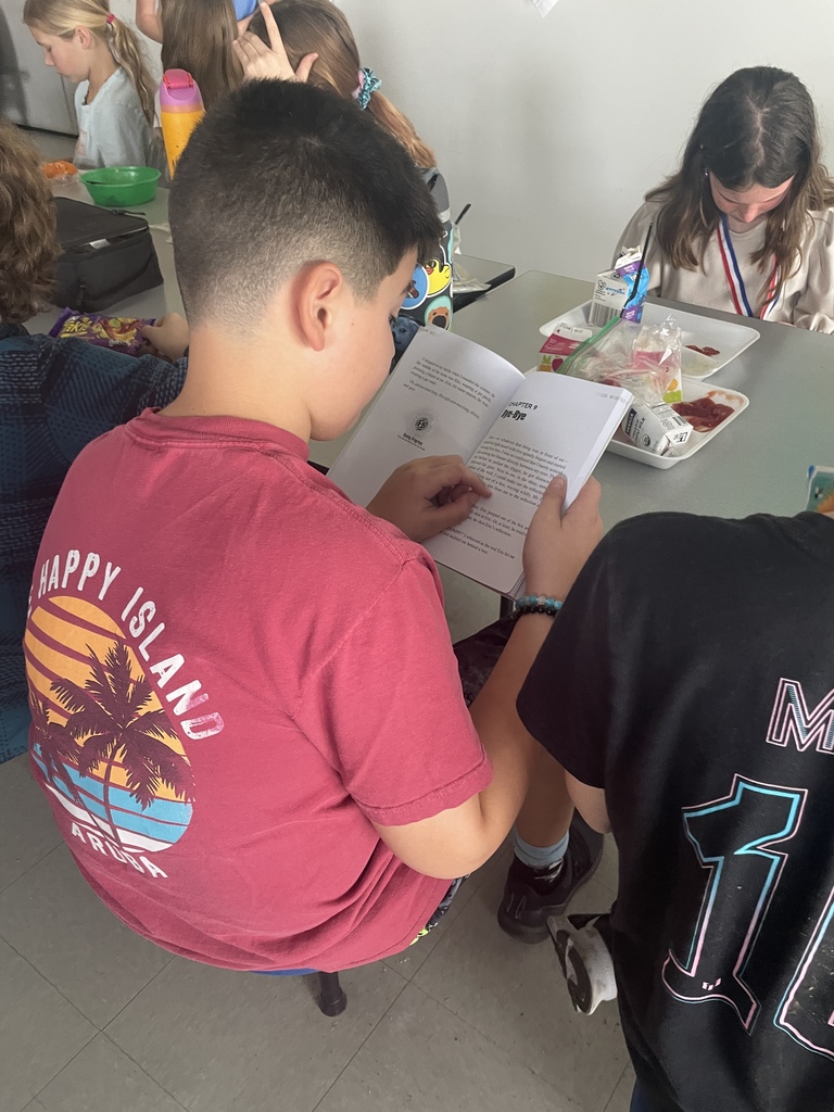 students reading at lunch