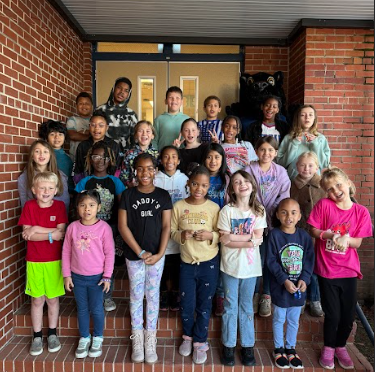 students of the week standing on school steps with the mascot