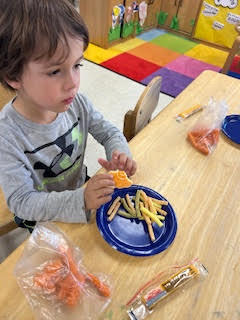 PreK working on a spring activity at their tables