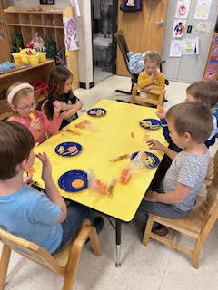 PreK working on a spring activity at their tables
