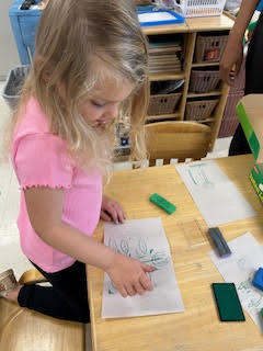 PreK working on a spring activity at their tables