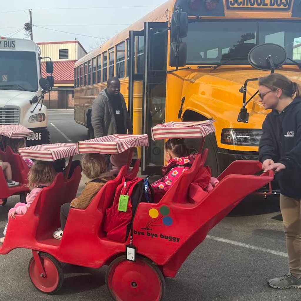 students being shown school bus
