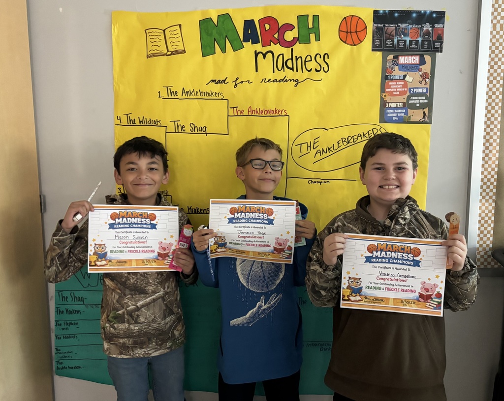 4th graders holding up certificates