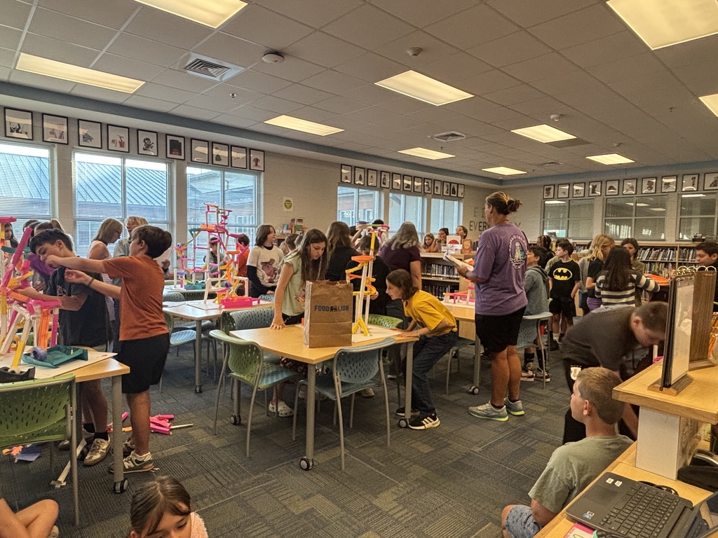 5th grade groups testing their paper rollercoaster designs