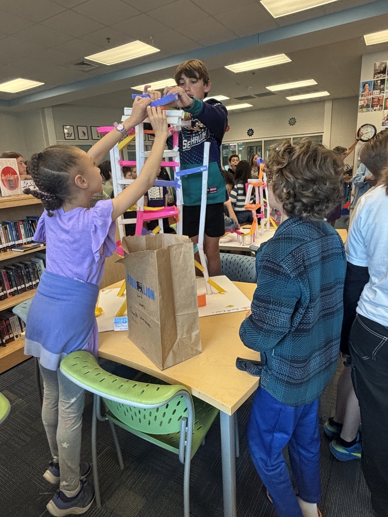 5th grade groups testing their paper rollercoaster designs