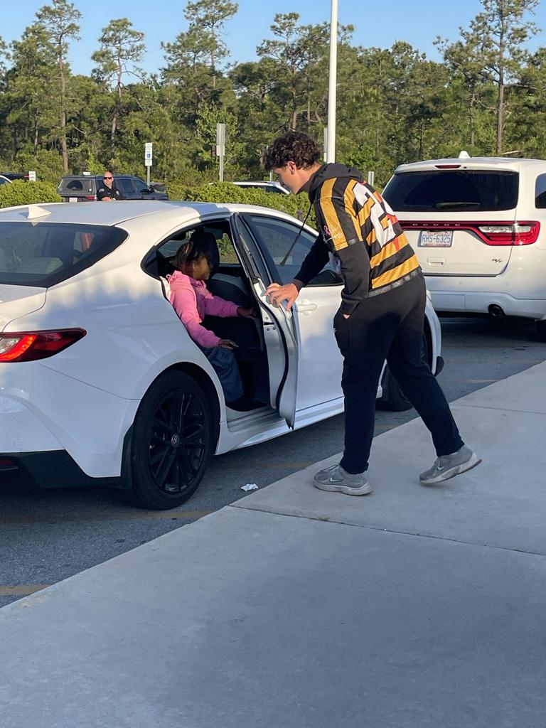 THS lacross players opening car doors in the morning