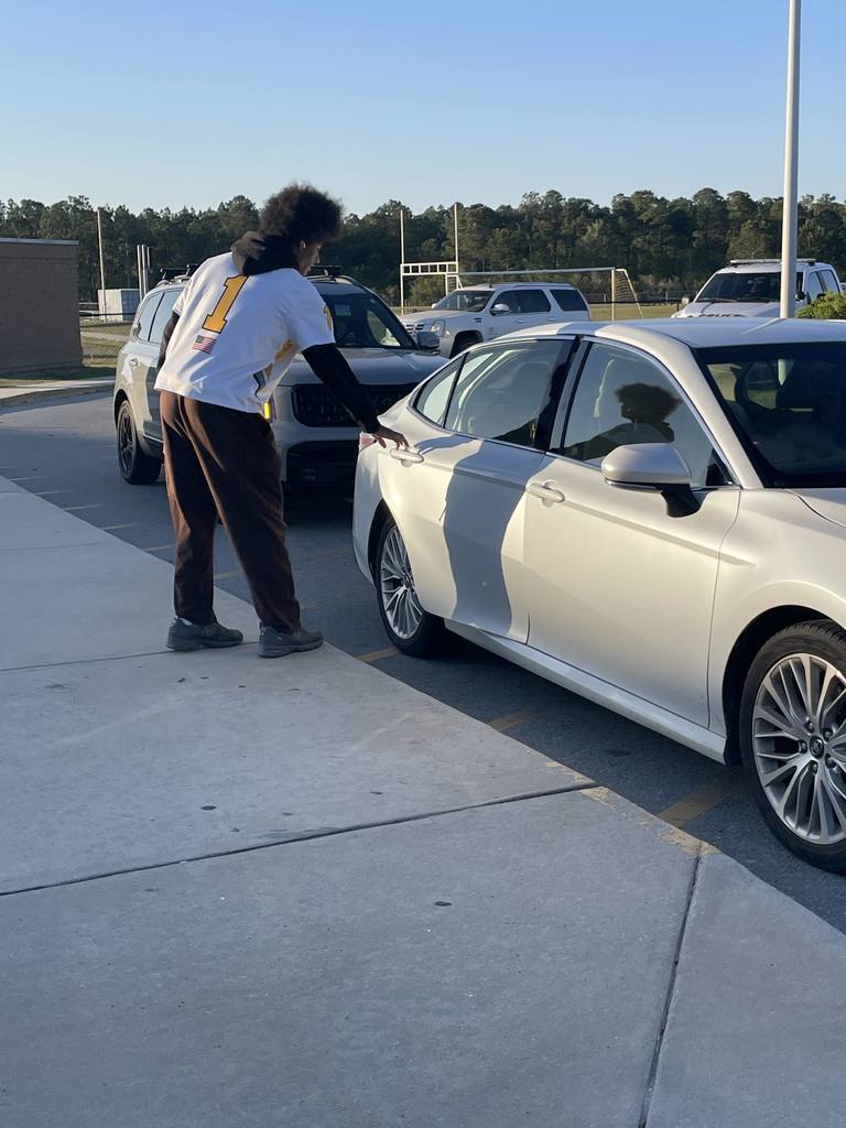 THS lacross players opening car doors in the morning