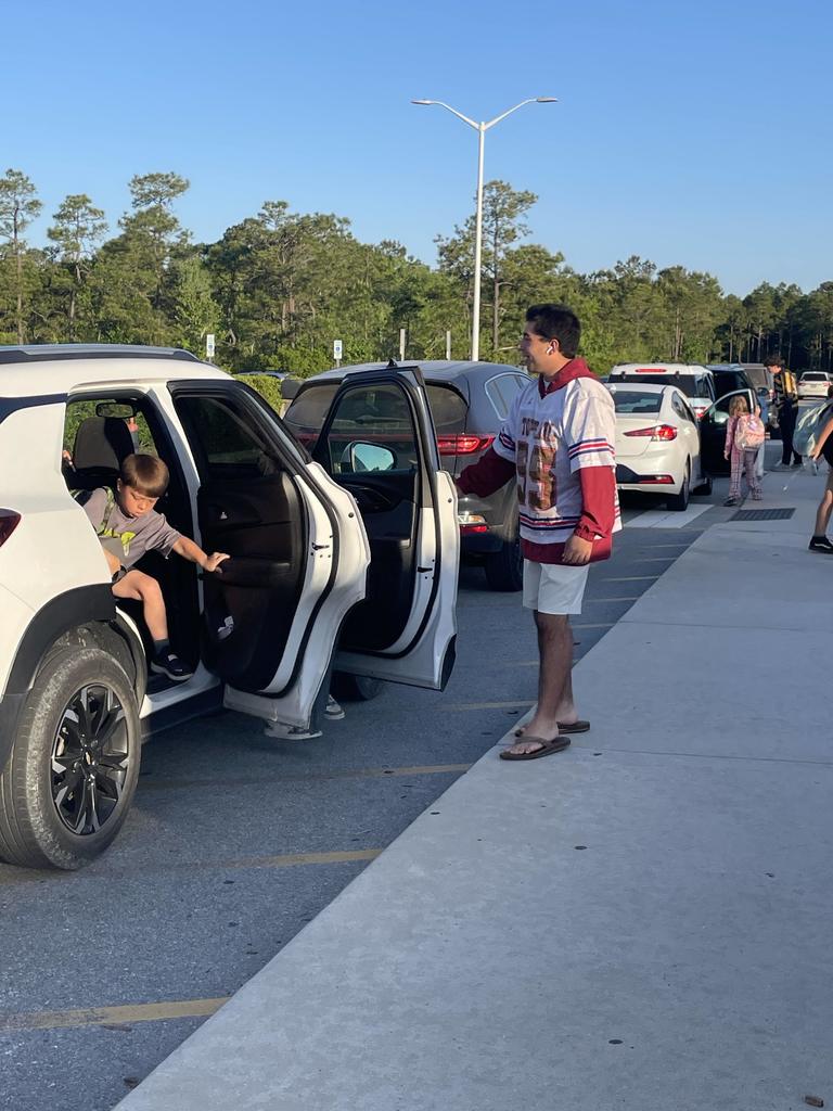 THS lacross players opening car doors in the morning