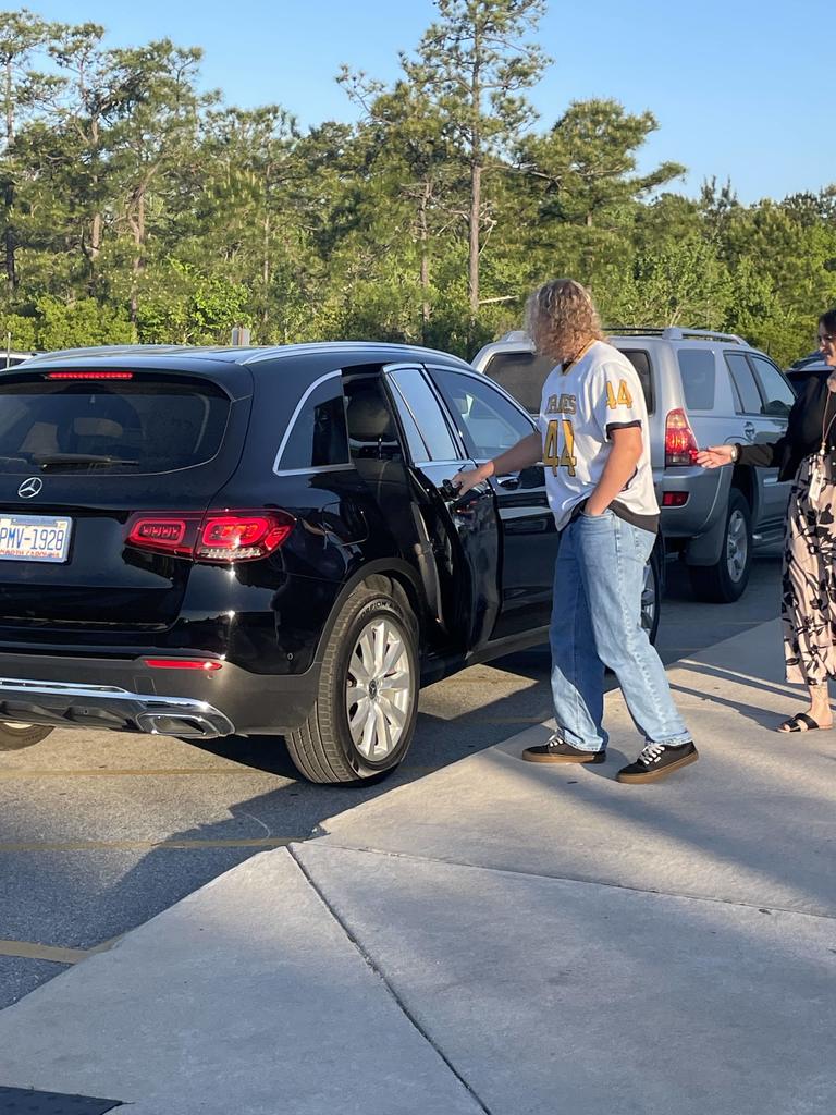 THS lacross players opening car doors in the morning