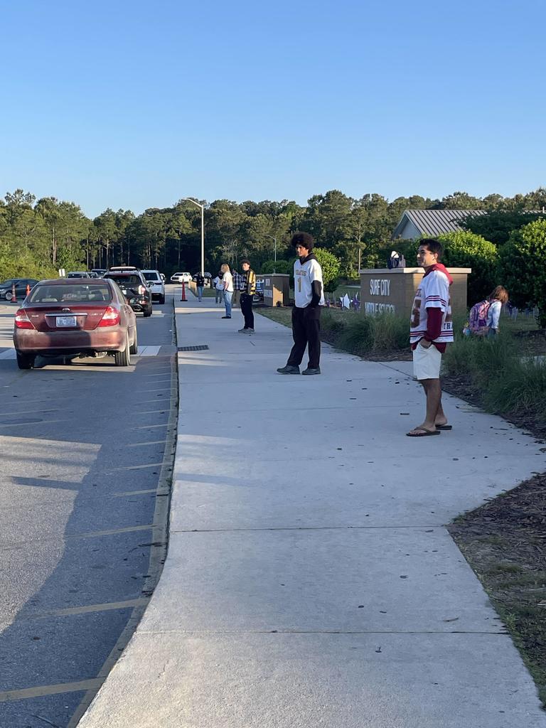 THS lacross players opening car doors in the morning