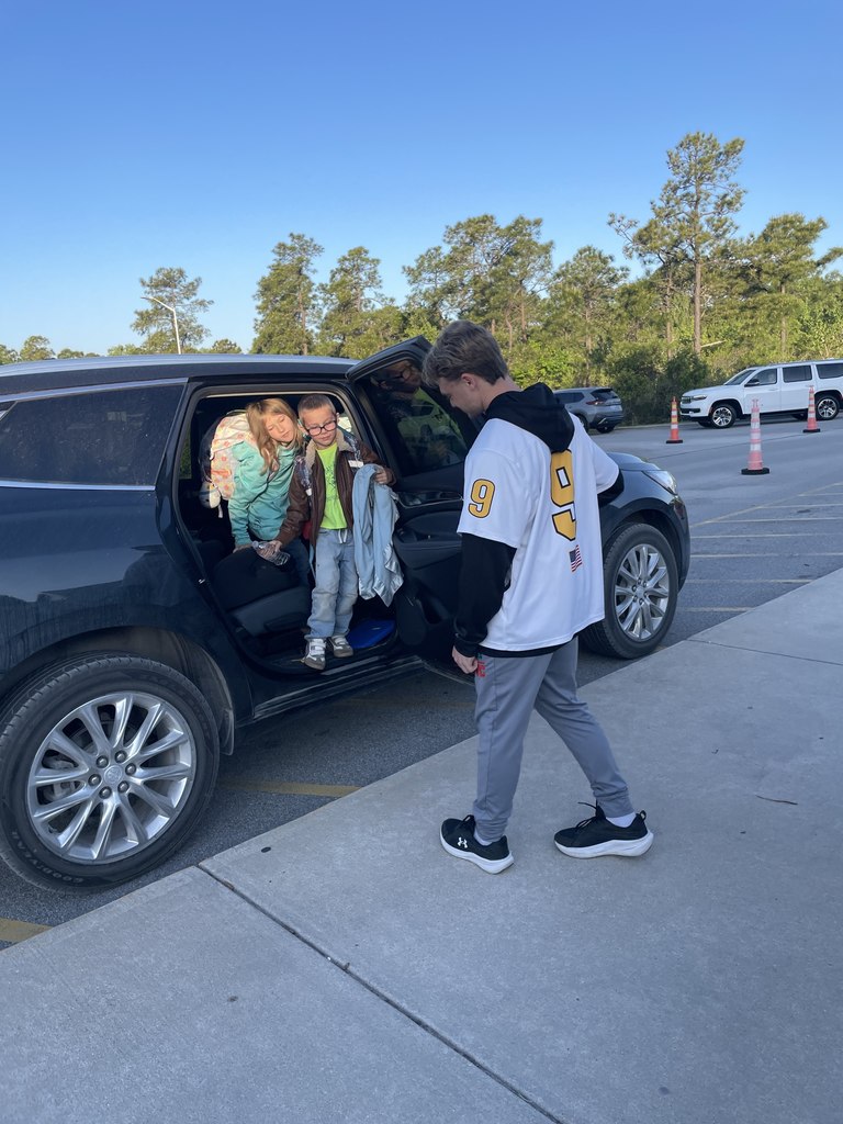 THS lacross players opening car doors in the morning