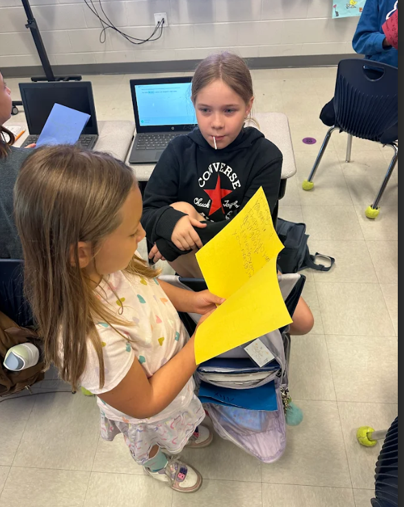 1st graders giving encouragement cards to 5th graders