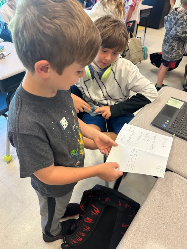 1st graders giving encouragement cards to 5th graders