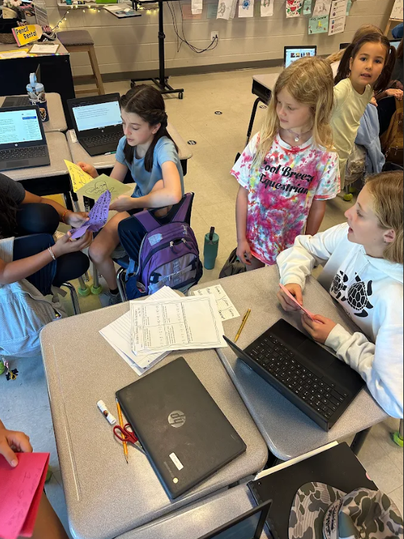 1st graders giving encouragement cards to 5th graders