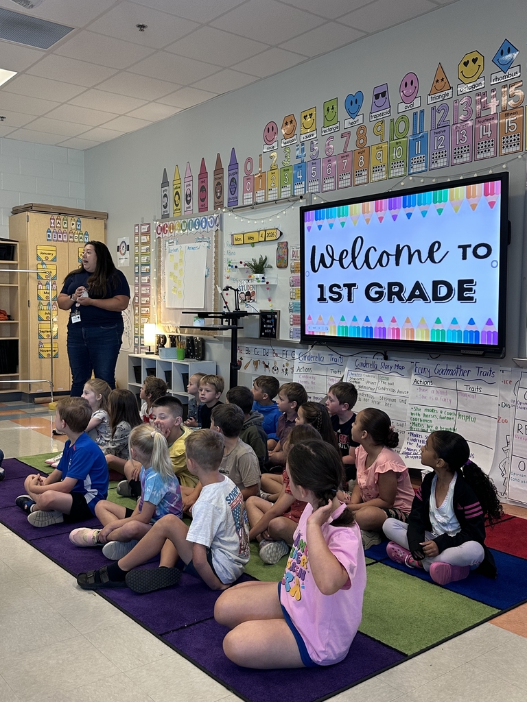 1st graders talking to Kindergarten students in their classroom