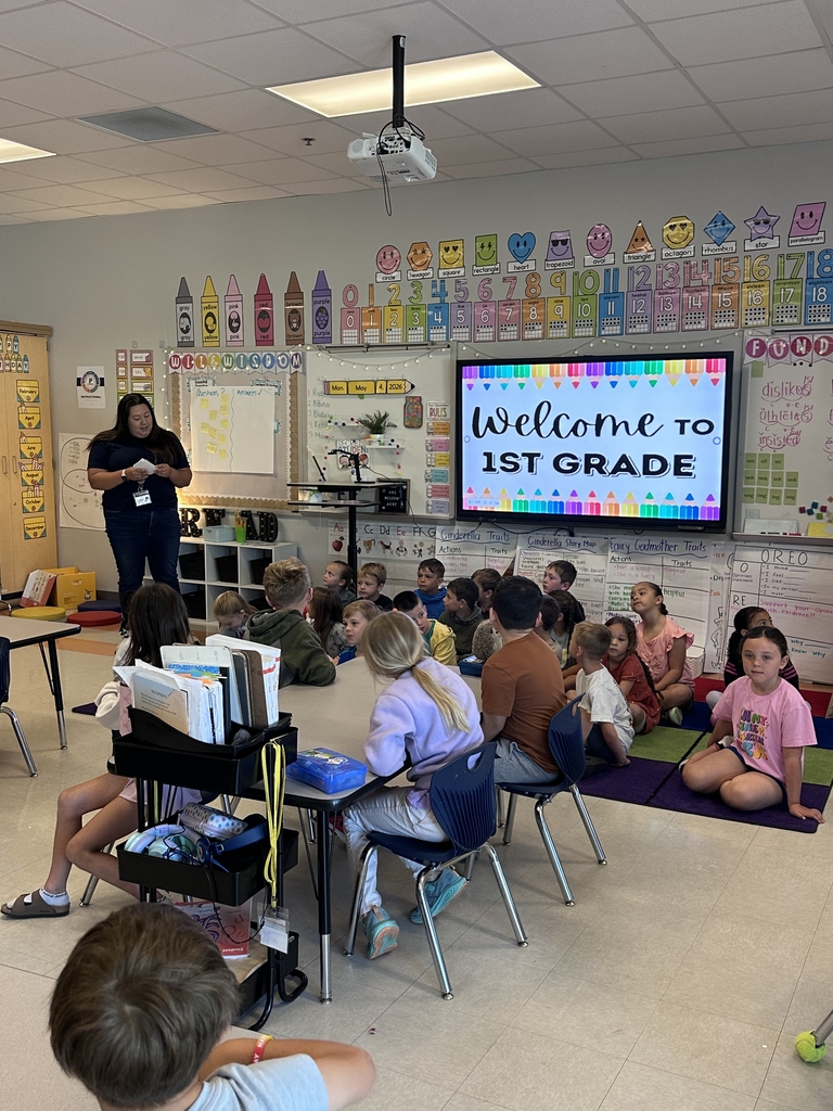 1st graders talking to Kindergarten students in their classroom