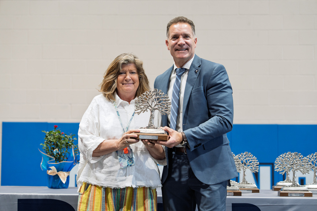 Mrs. Radcliff receiving a reward for her year of dedication from Dr. Bredlove. at the PCS Retirement Celebration.