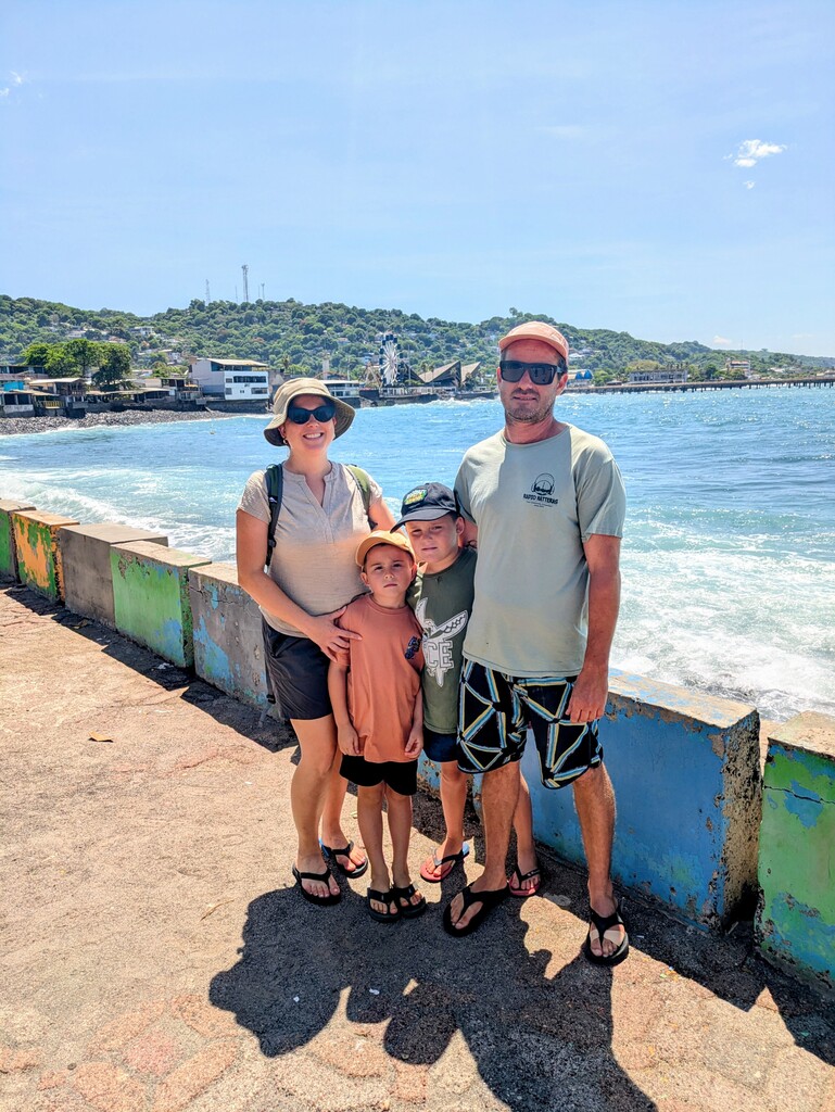 family posing in front of beach wearing SCE tshirt