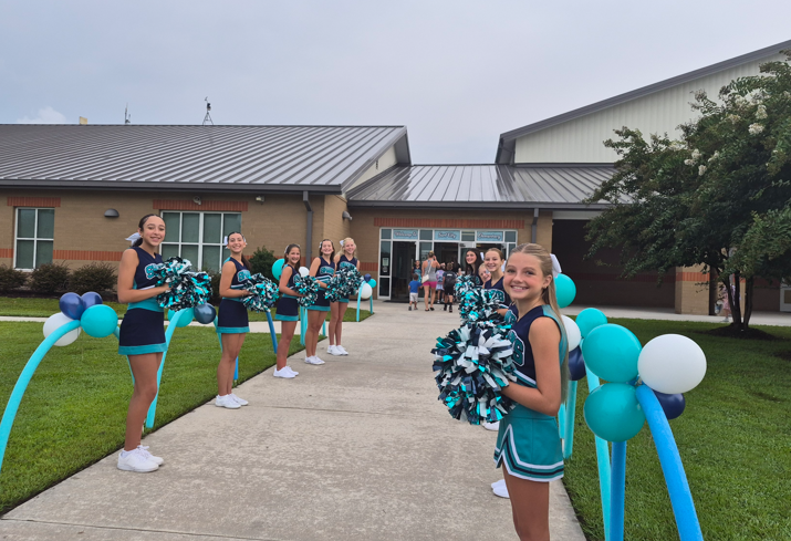 SCm cheerleaders welcoming students in this morning