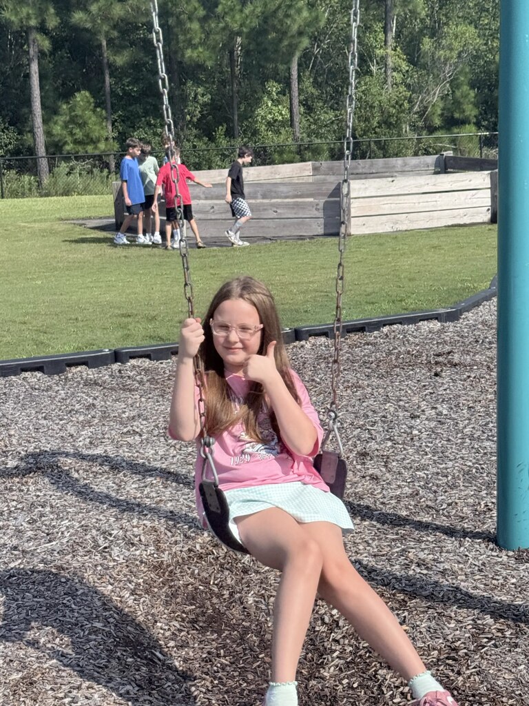 student swinging on the swings