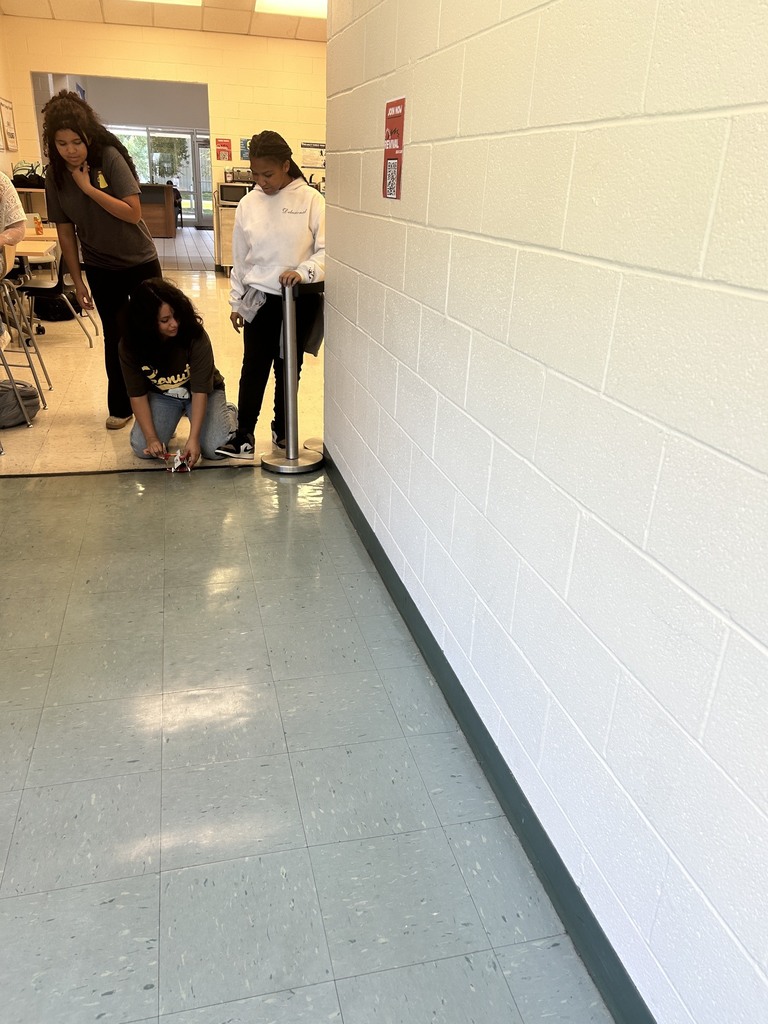 Students prepare to race rover down hallway