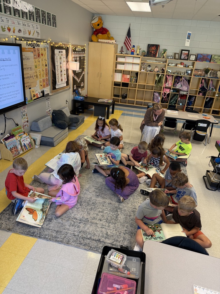 first grade students working on the carpet 