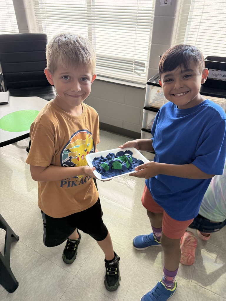 3rd grade students showing off their playdough landform creations