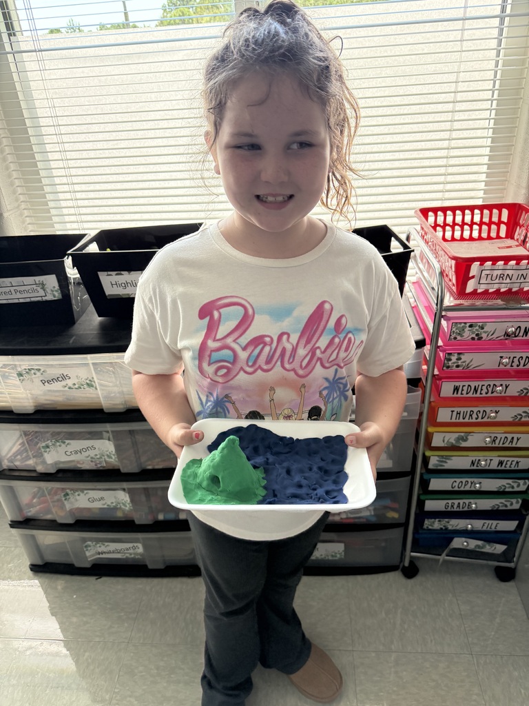 3rd grade students showing off their playdough landform creations