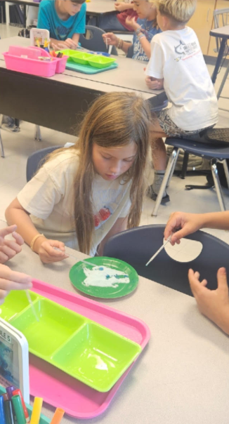 5th graders working on a science experiment