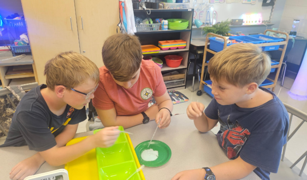 5th graders working on a science experiment