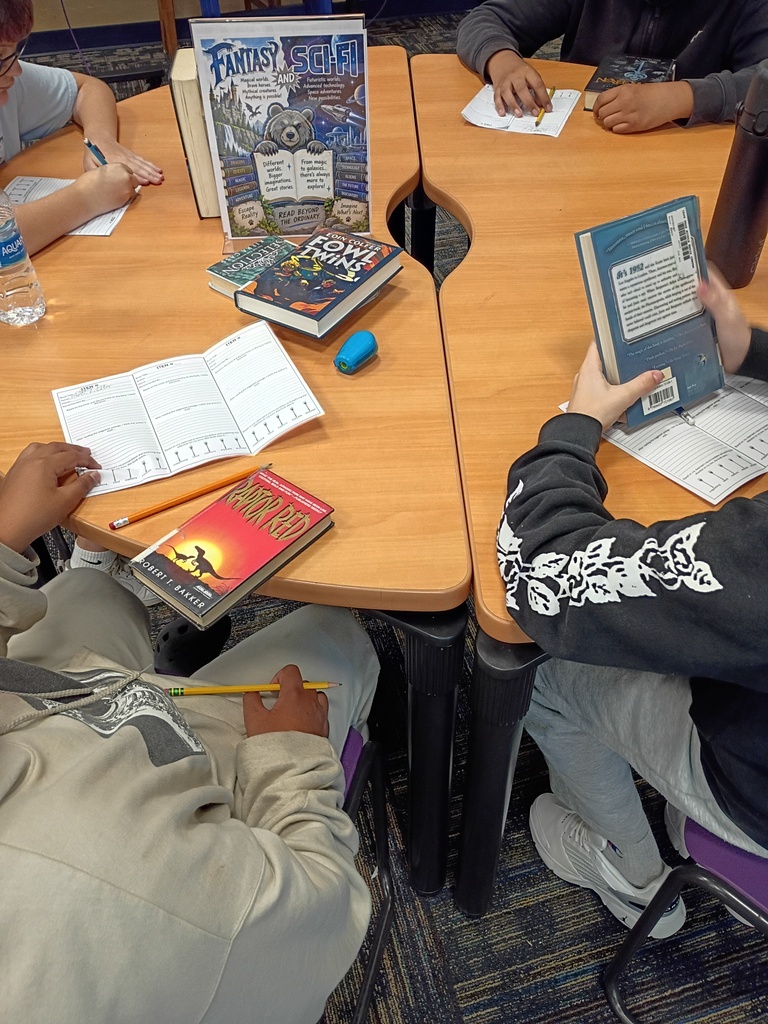 Ms. Harvey's students participating in a book tasting activity in the media center.
