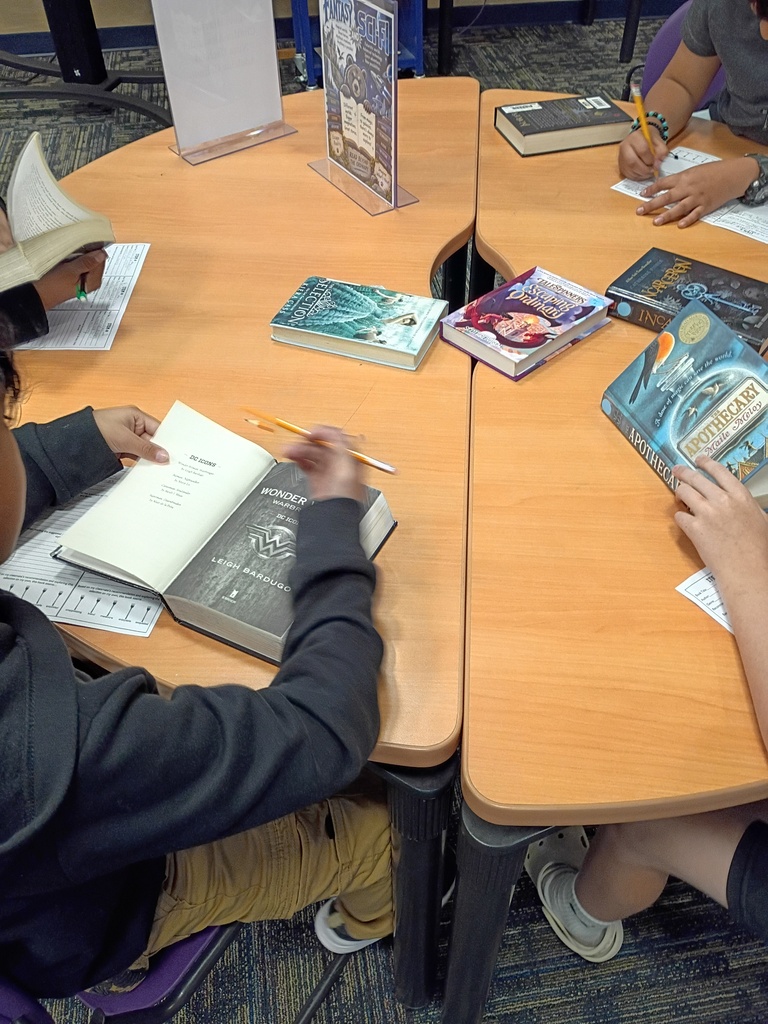 Ms. Harvey's students participating in a book tasting activity in the media center.