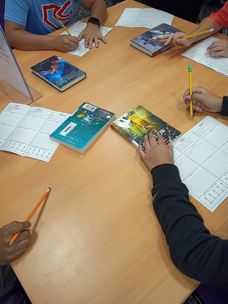 Ms. Harvey's students participating in a book tasting activity in the media center.