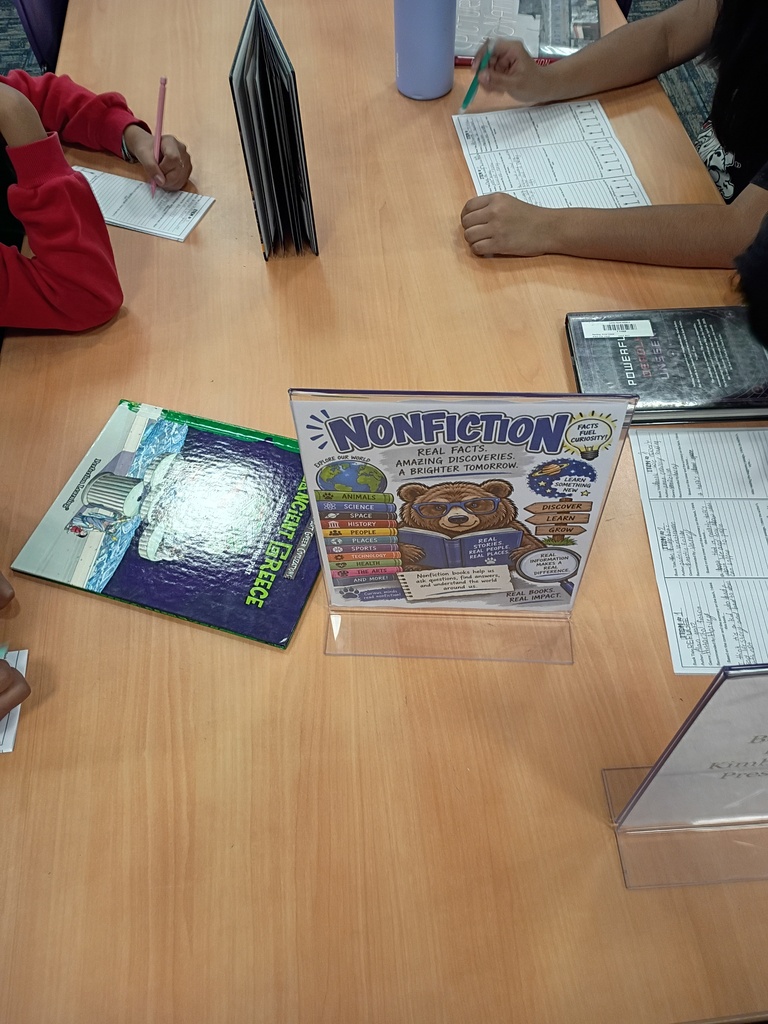 Ms. Harvey's students participating in a book tasting activity in the media center.