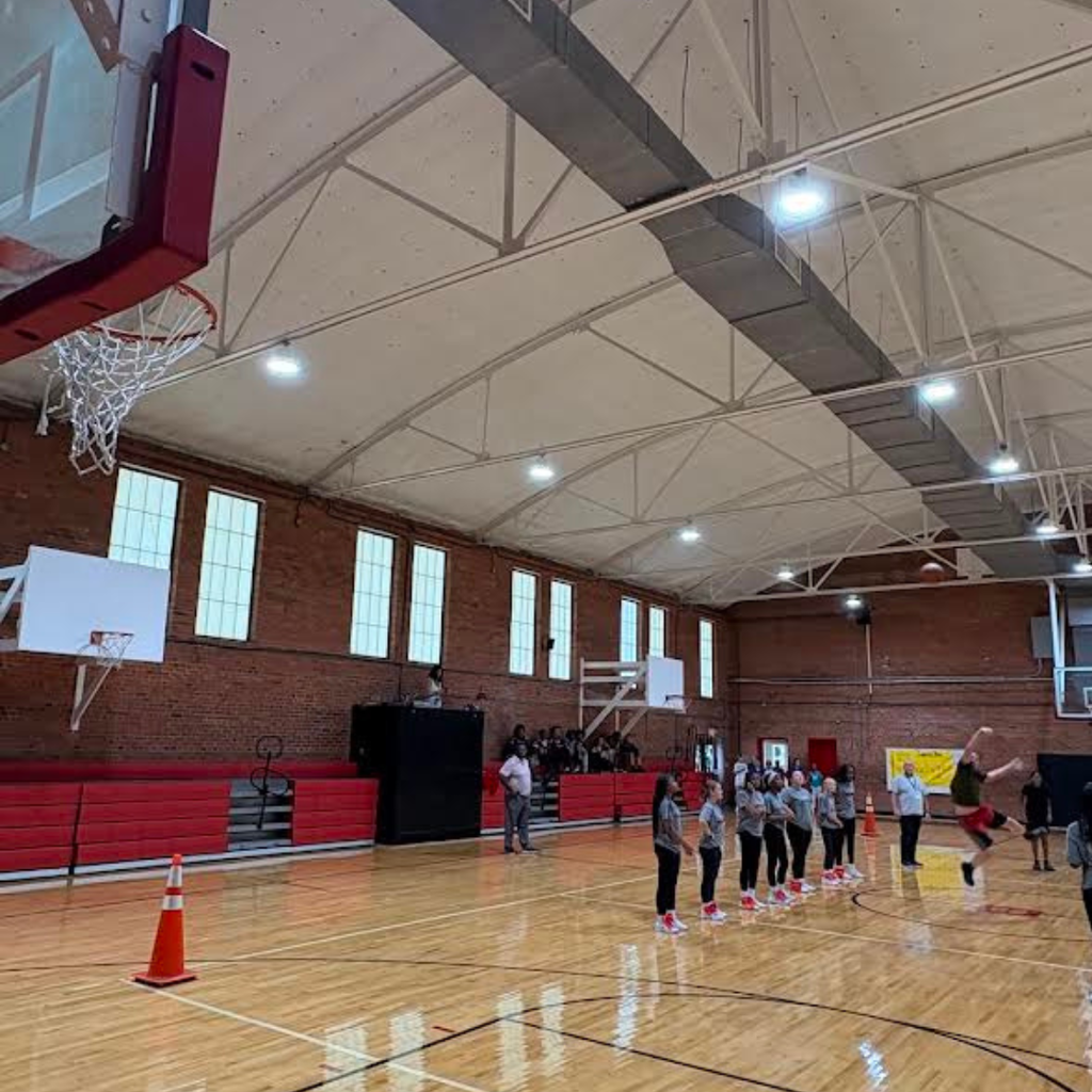students participating in half court shot at pep rally