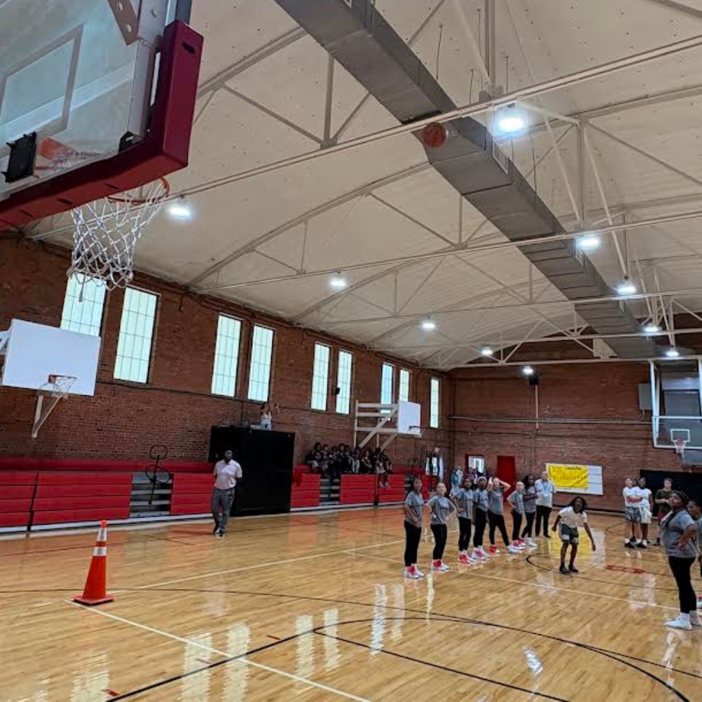 students participating in half court shot at pep rally