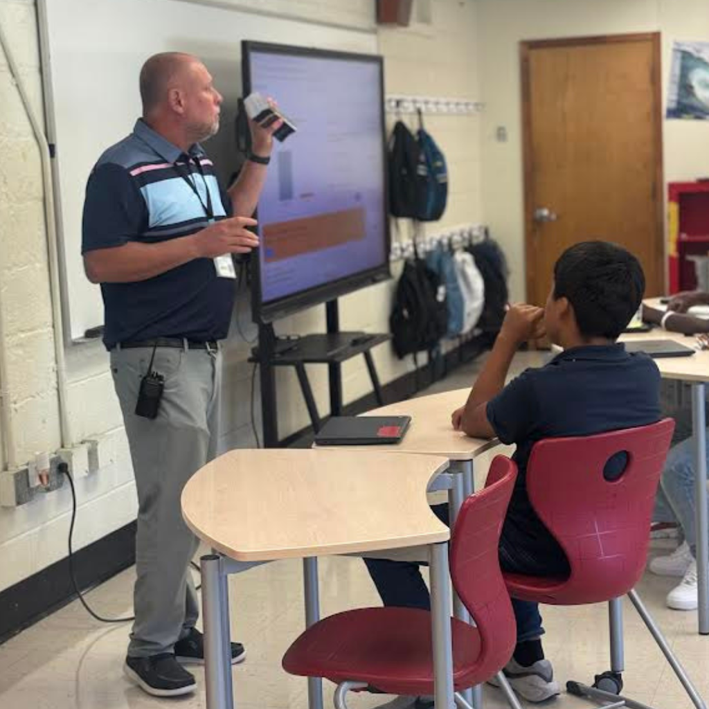 principal speaking to students in a classroom