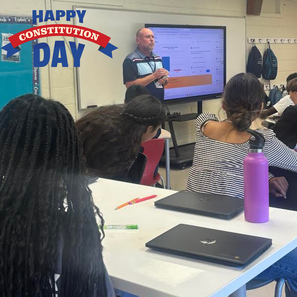 principal speaking to students in a classroom