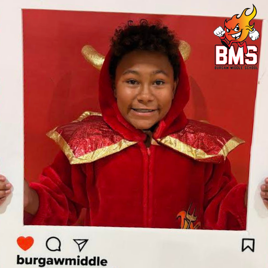student wearing mascot uniform and holding instagram sign