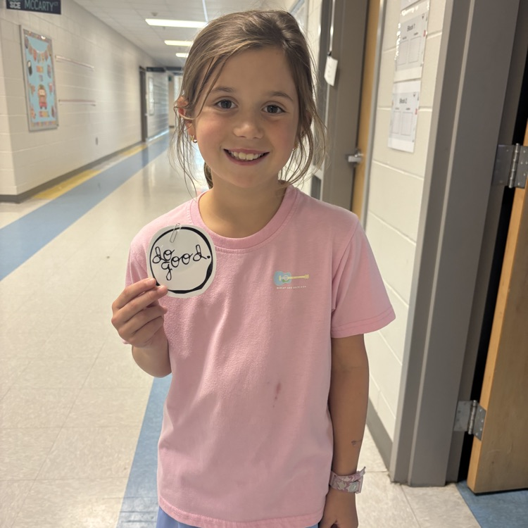 student holding up a do good award 
